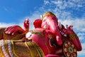 Close Up Beautiful Big Pink colors of Hindu god lord Ganesha with white cloud and blue sky background Royalty Free Stock Photo