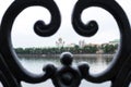 Close-up black cast fence of Yekaterinburg embankment with view of the Temple on lood through it. Royalty Free Stock Photo
