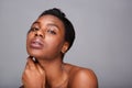 Close up beautiful black woman with hand to face and bare shoulders Royalty Free Stock Photo