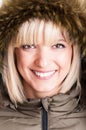 Close-up of beautiful blonde girl with fur hood on Royalty Free Stock Photo