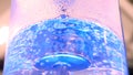 Close up for beautiful, blue clear water with bubbles rising up in plastic reservoir. Media. Bubbles of air moving in Royalty Free Stock Photo