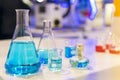 Close up of beautiful blue colorful chemistry liquid in various laboratory flask for science