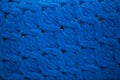 Close-up, beautiful blue plush woolen blanket with beautiful knit, concept of warmth and coziness, space for an inscription Royalty Free Stock Photo