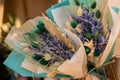 Close up: beautiful bouquets of purple lavender flowers in craft paper cornets