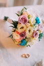 Close-up of beautiful bridal bouquet with pair golden wedding rings Royalty Free Stock Photo