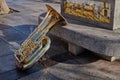 Close-up of a beautiful and bright tuba resting on a stone bench with ornament in Toledo, Spain Royalty Free Stock Photo