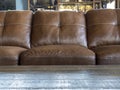 Beautiful, brown leather couch with a wooden table in front of it inside of a restaurant Royalty Free Stock Photo