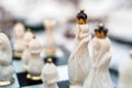 Close up of beautiful chess on table in room. Selective focus of porcelain chess pieces on chessboard