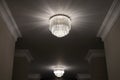 Close-up of a beautiful crystal chandelier. Round expensive classic chandelier with lights turned on beautifully