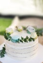 Close-up of a beautiful delicious sweet cake white tall and macarons and minimalistic decor from above Royalty Free Stock Photo