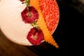 Close-up of beautiful dried flowers and orange peel decorating glass of frothy cocktail