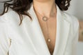 Close up of beautiful elegant young woman wearing an expensive pearl necklace in a white blazer Royalty Free Stock Photo