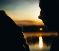 Close-up of beautiful emotional bride holding face of handsome groom, newlywed couple looking into each other eyes