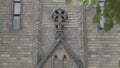 Close-up of beautiful facade of ancient church. Action. Architectural symbol of Anglican Church. Beautiful details of