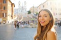 Close up of beautiful fashion woman in Piazza di Spagna square in Rome with Spanish Steps and Barcaccia fountain on the background