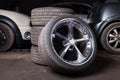 A close-up of beautiful fashionable wheels for a car, three folded on top of each other and one in first place with a shiny chrome