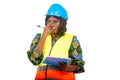 Close up of a beautiful female engineer with clipboard, pensive Royalty Free Stock Photo