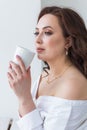 Close up of beautiful female hands holding big white cup of cappuccino coffee. Royalty Free Stock Photo