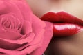 Lips with bright lipgloss makeup. Perfect clean skin, fresh lip make-up. Beautiful spa with tender pink rose flower Royalty Free Stock Photo