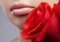 Close-up beautiful female lips with bright lipgloss makeup. Perfect clean skin, red lip make-up