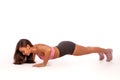 Close-up of a beautiful fitness girl in a sports top doing push-ups. Workout at home. Simple sports exercises for everyone