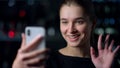 Close up of beautiful girl having video call with iPhone outdoors.Video chat. Royalty Free Stock Photo