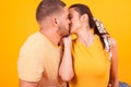 Close up of beautiful girlfriend kissing her boyfriend in studio