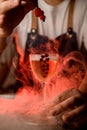 Close-up of beautiful glass with drink with decorative red hearts on the bar and smoke around it