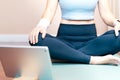 Close up of beautiful and healthy woman`s body waist and hips sitting in easy seat pose, lotus position to warm up before join in Royalty Free Stock Photo