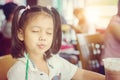 Close up of beautiful little cute girl drinking iced chocolate in coffee shop, Happy and enjoy kid concept Royalty Free Stock Photo