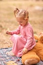 Little cute girl in a pink dress in the fresh air