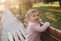 Close up of beautiful little smiled girl. Happy baby girl in autumn park. Ten month baby smile