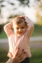 Close up of beautiful little smiled girl. Happy baby girl in autumn park. Ten month baby smile