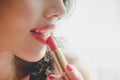 Close up beautiful luxury young woman applying lip liner to nude red lips. Close up shot and make up Royalty Free Stock Photo