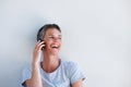 Close up beautiful middle age woman talking on mobile phone against white wall Royalty Free Stock Photo
