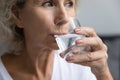 Close up beautiful middle aged woman drinking pure mineral water Royalty Free Stock Photo