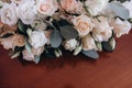 Close up of beautiful modern and stylish wedding bouquet of white, pink roses and eucalyptus greenery on wooden background. Royalty Free Stock Photo