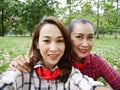 Beautiful Asia mother and daughter are selfie photo relaxation time in the garden park.