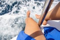 Close-up of beautiful sexy female legs on a yacht, sailing on a yacht, summer vacation, conceptual image of pleasure and enjoyment