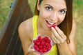 Close up of beautiful sexy woman eating berries in the park