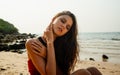 Close-up beautiful sexy young suntanned woman posing in seductive energetic posture in sandy beach. Sexy tanned body, long dark Royalty Free Stock Photo