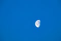 Close up beautiful shot of half moon at bright blue clear sky Royalty Free Stock Photo