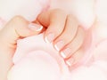 Close-up beautiful sophisticated female hands with pink flowers on white background. Concept hand care, anti Royalty Free Stock Photo