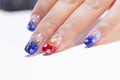 Close up beautiful sparkling red and blue glitter ombre style on woman acrylic fingernail decorated with golden sta