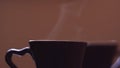 Close-up of beautiful steam rising from mugs with hot drink. Concept. Rising steam from steaming mugs of coffee. Hot