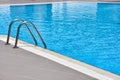 Close up of a beautiful swiming pool and swimming pool ladder Royalty Free Stock Photo