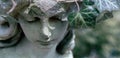 Close up beautiful tender bow of angel looking down. Copy space. Ancient stone statue Royalty Free Stock Photo