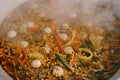 Close-up of the beautiful texture of the surface of the cooked Uzbek pilaf in a cauldron.