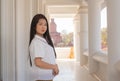 Close up of beautiful thai woman in a white traditional thai dress is standing in white temple with smilingly face Royalty Free Stock Photo