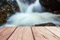 Close-up beautiful waterfall in deep forest and wood pier Royalty Free Stock Photo